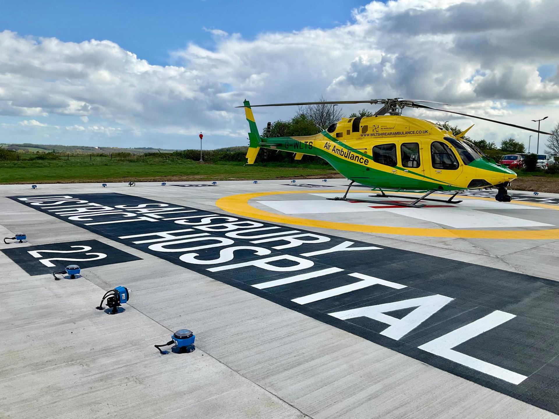Yellow and green helicopter landed at Salisbury District Hospital's new helipad