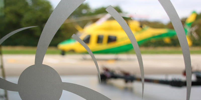 The Wiltshire Air Ambulance helicopter in the background of a frosted window