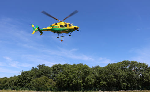 A photoshopped Dachshund dangling from the Wiltshire AIr Ambulance helicopter