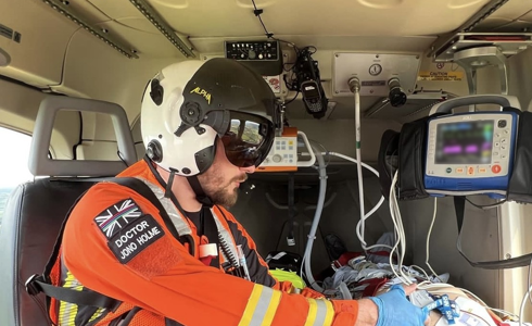 Dr Jono Holme delivering drugs to a patient in flight