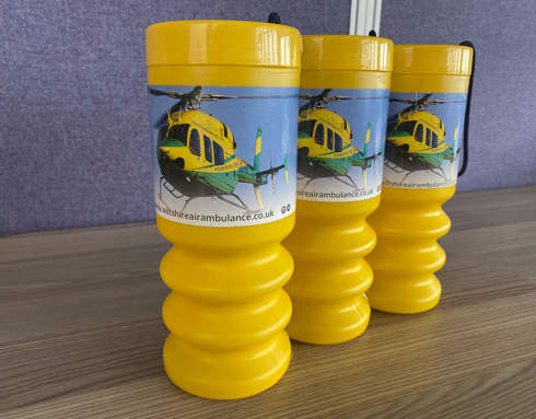 A group of yellow collection tins.