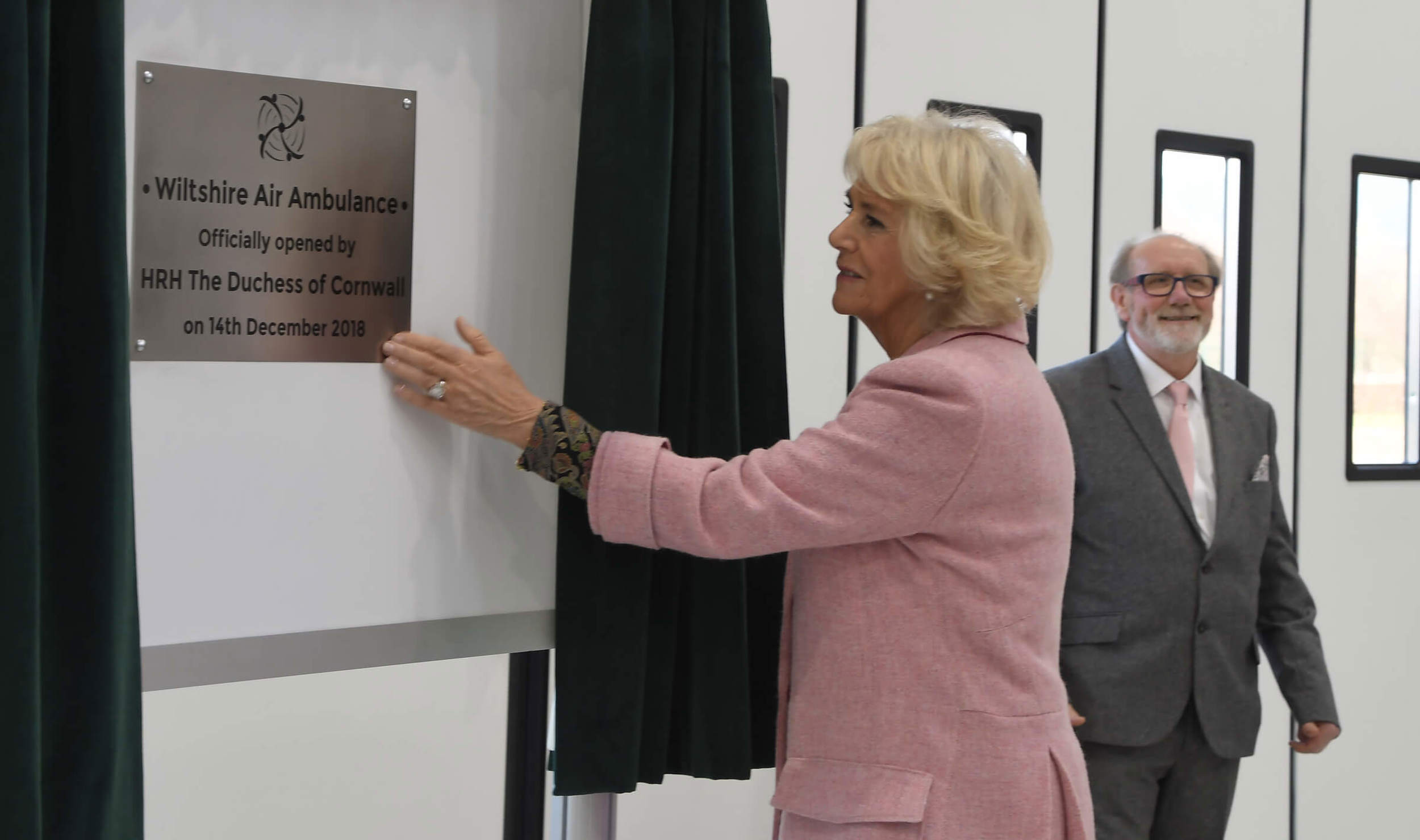 The Queen Consort unveiling the opening plaque for Wiltshire Air Ambulance's new airbase.