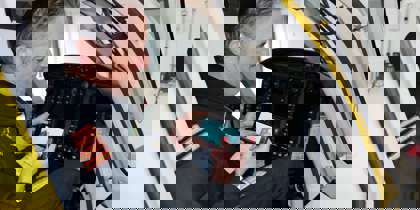 A pilot playing a helifun game on their phone inside the cockpit of the Bell-429 helicopter.