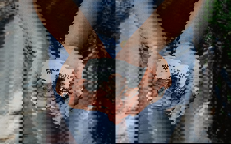 A small handwritten note stating 'make a change' with a variety of coins.