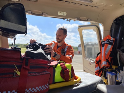 Dr Jono Holme replenishing an equipment bag in the Wiltshire Air Ambulance helicopter
