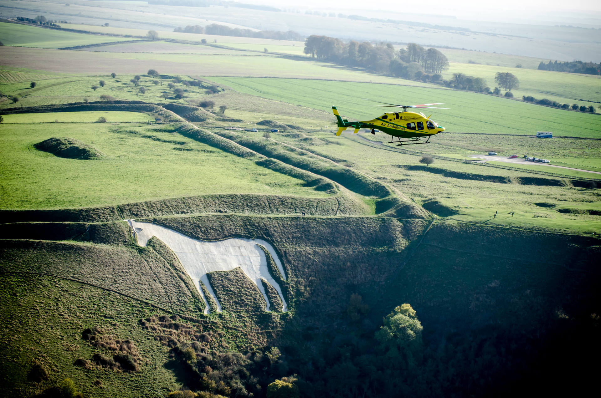 The helicopter in flight over a White Horse in Wiltshire.