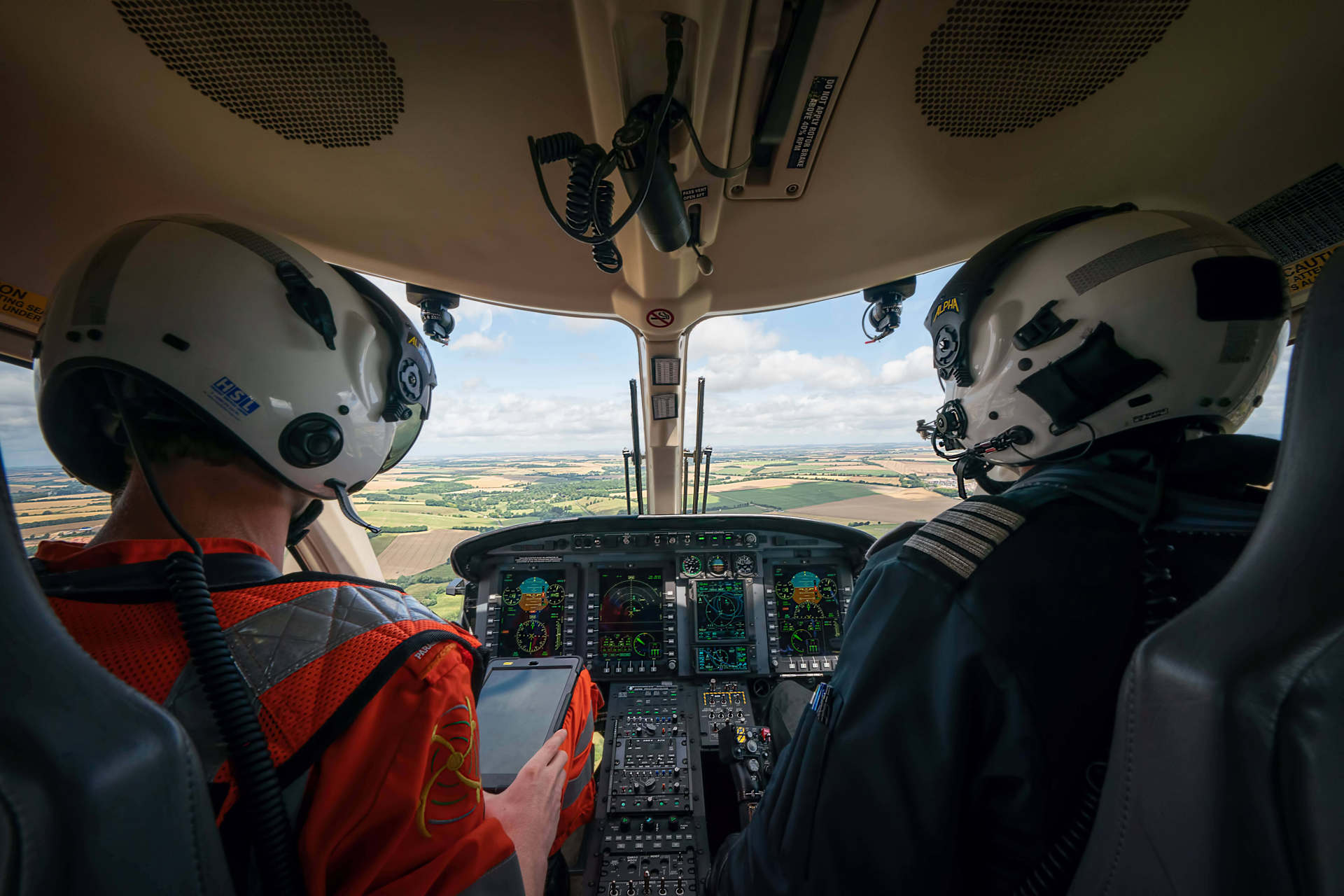 A paramedic and pilot sat in the cockpit of the helicopter whilst in flight.