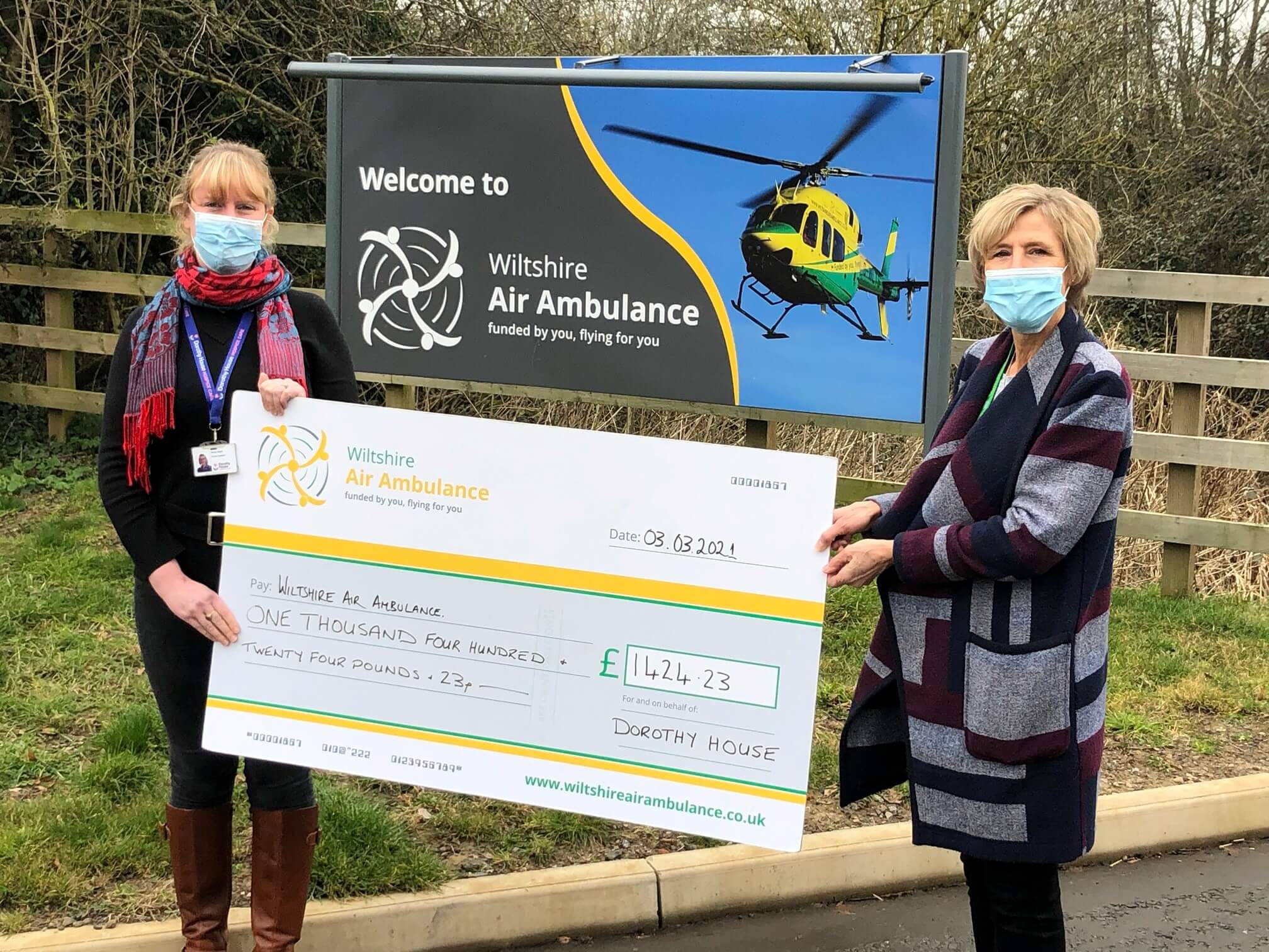 Emily with Wiltshire Air Ambulance's Cas presenting a cheque on behalf of Dorothy House for £1,424.23