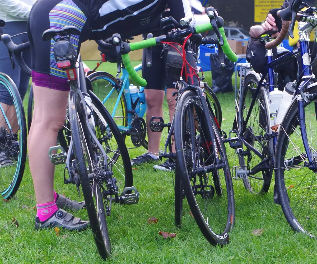 A photo of road bikes and cyclists at an event A photo of road bikes and cyclists at an event
