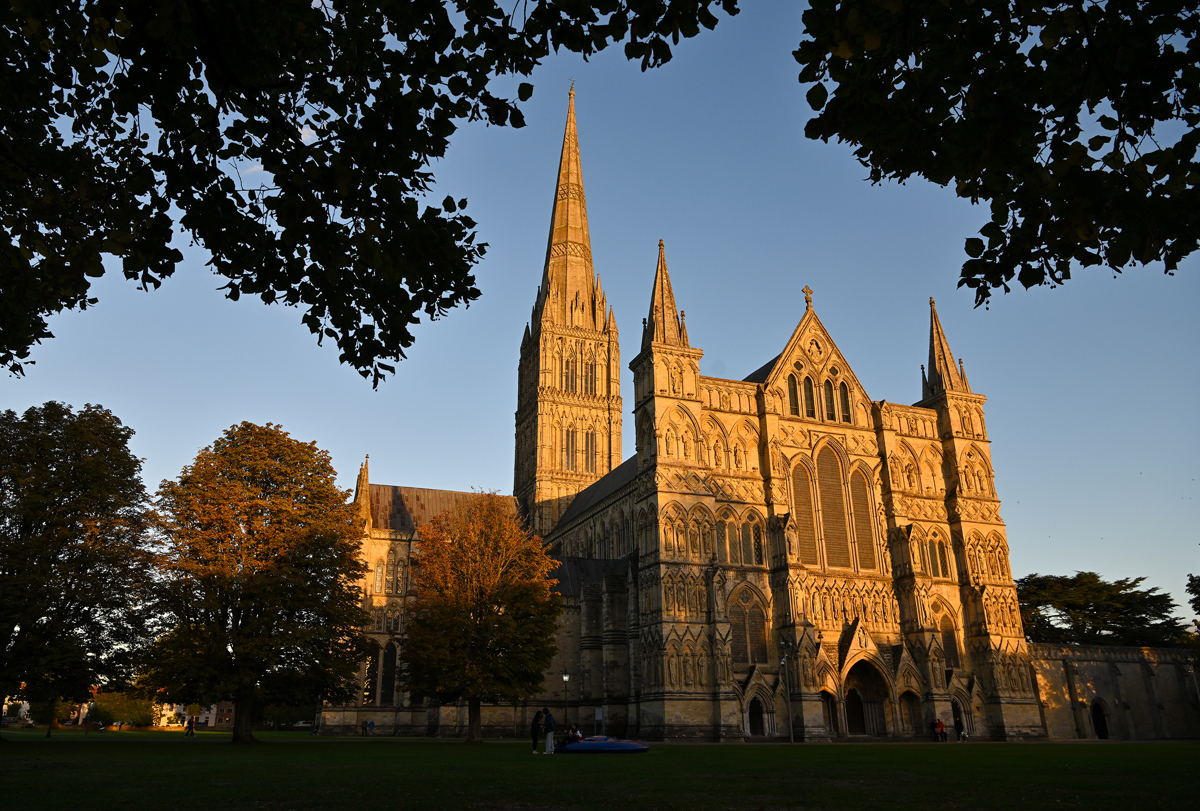 A photo of Salisbury cathedral with a sunset