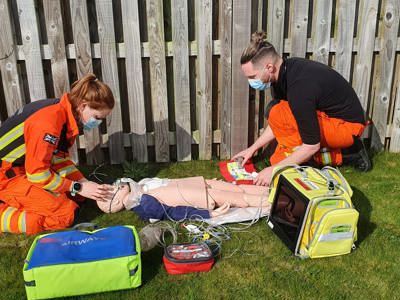 Critical care paramedic Sophie Holt and Dr Jono Holme in a training scenario using medical equipment and a mannequin.