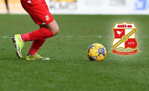 Swindon Town football player kicking ball, with STFC logo
