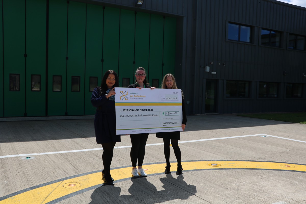 A photo of two women from Barratt David Wilson Homes presenting a cheque