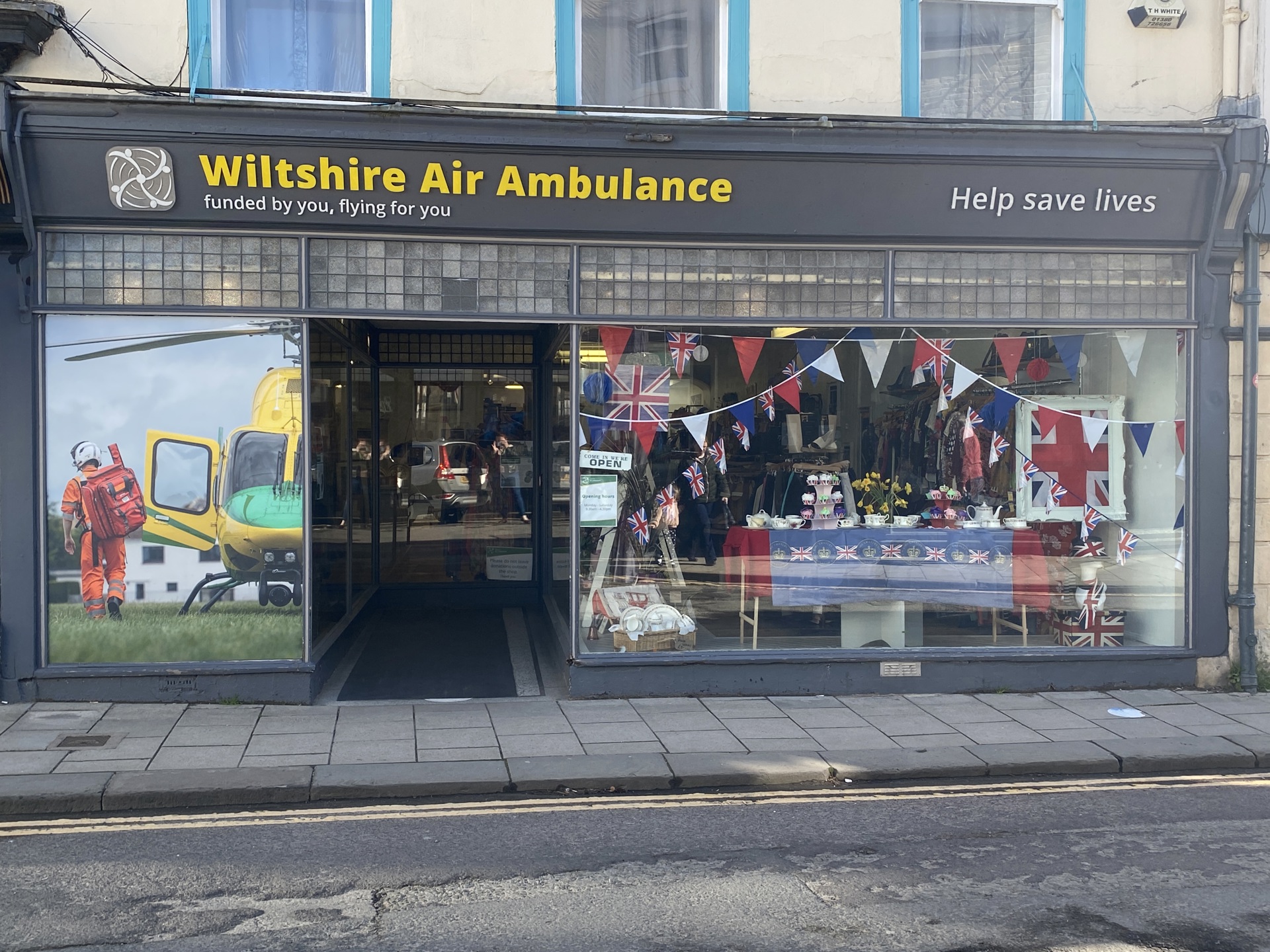 The Devizes Charity Shop decorated with bunting and flags to celebrate The Coronation in May 2023