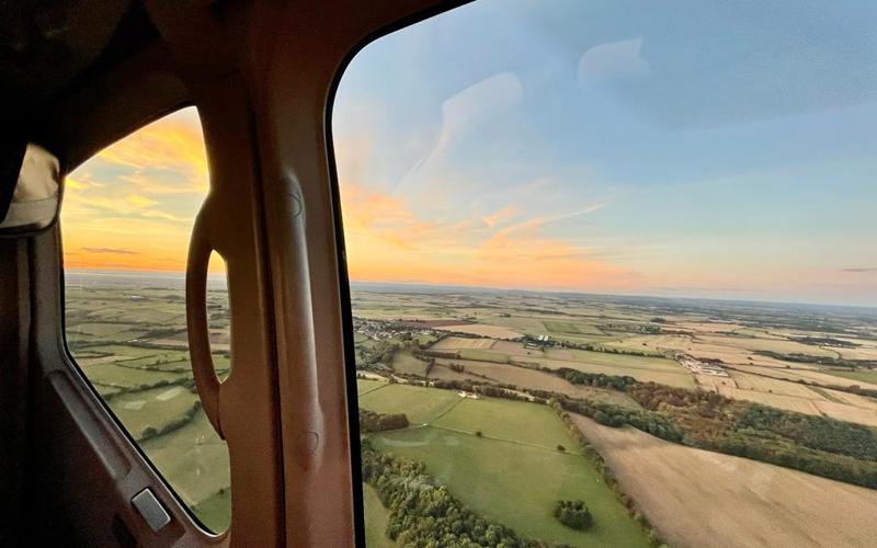 A view of a sunset from the helicopter