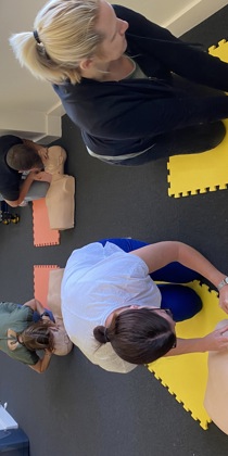 Members of Goodings Accounts taking part in CPR training with manikins