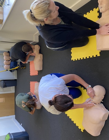 Members of Goodings Accounts taking part in CPR training with manikins