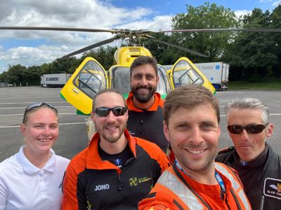 A photo of a pilot, two paramedics, a doctor and an ambassador standing in front of the Wiltshire Air Ambulance helicopter