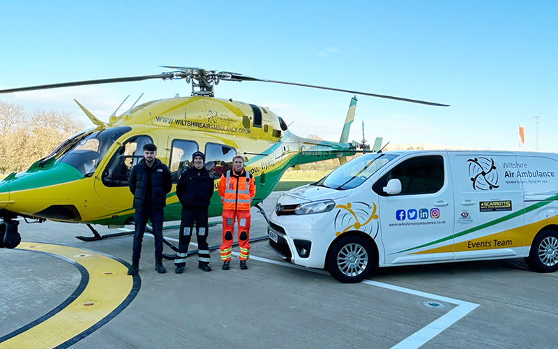 The WAA helicopter with the charity's new events van on the helipad