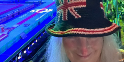A volunteer wearing a crochet hat featuring the GB flag