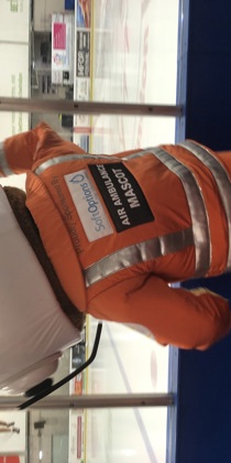 An air ambulance paramedic mascot cheering at the side of an ice rink