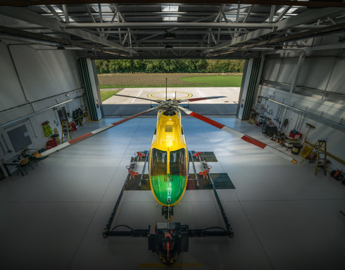 An aerial view of the Wiltshire Air Ambulance helicopter in the hangar