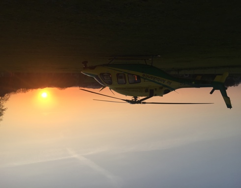 Wiltshire Air Ambulance in front of an orange sunset