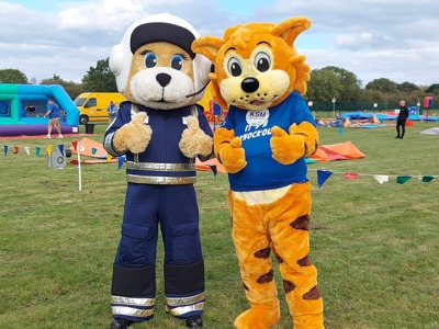 Two mascots posing at Wiltshire Air Ambulance's It's a Knockout 2023