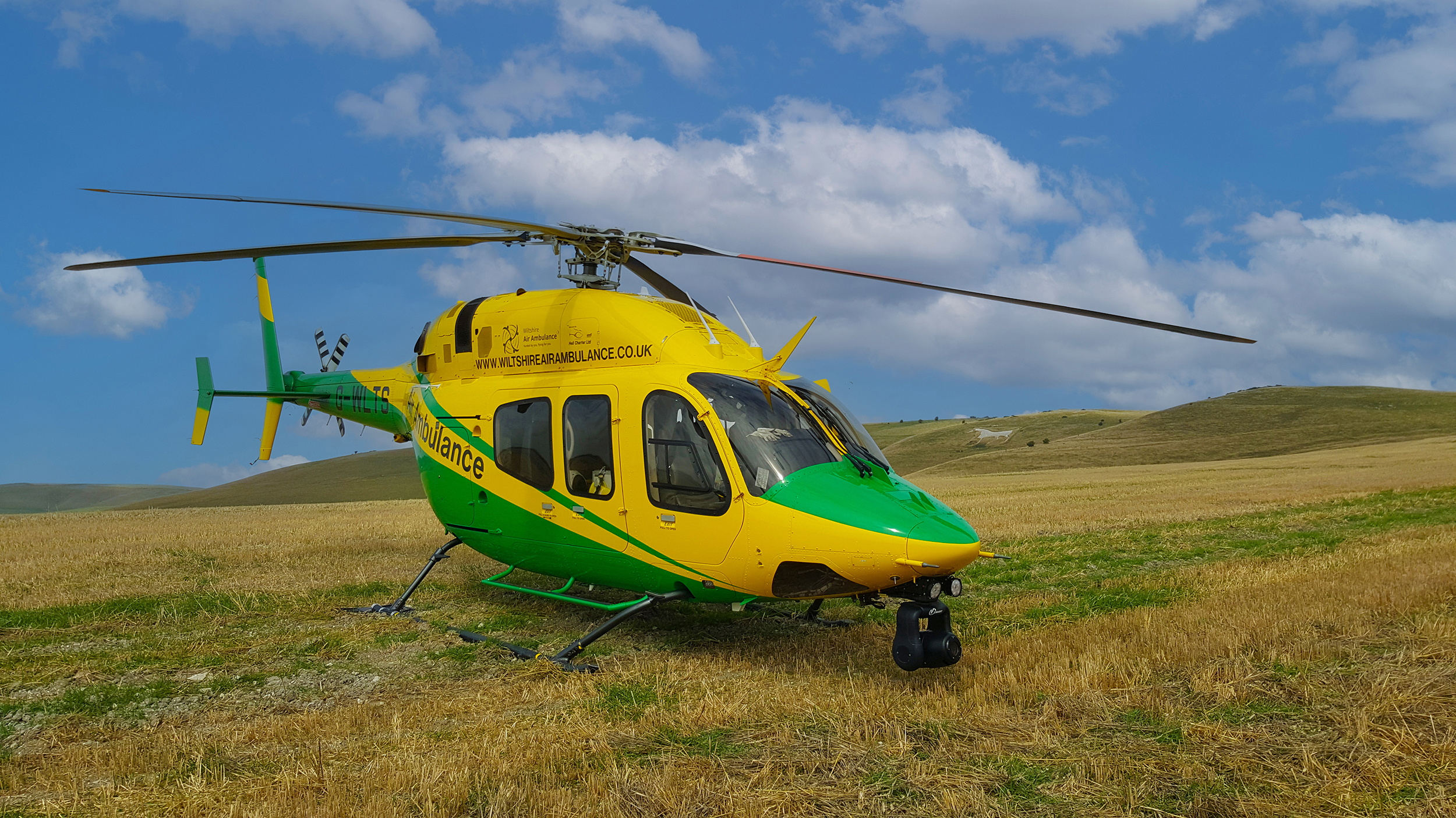 Wiltshire Air Ambulance's helicopter with Pewsey's white horse in the background