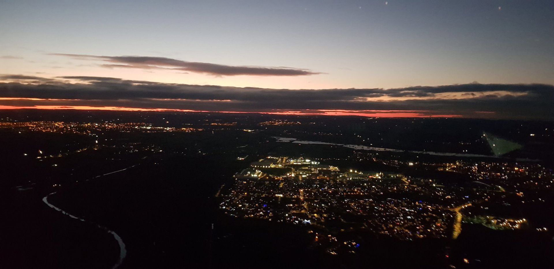 A photo of a town from above with a sunset