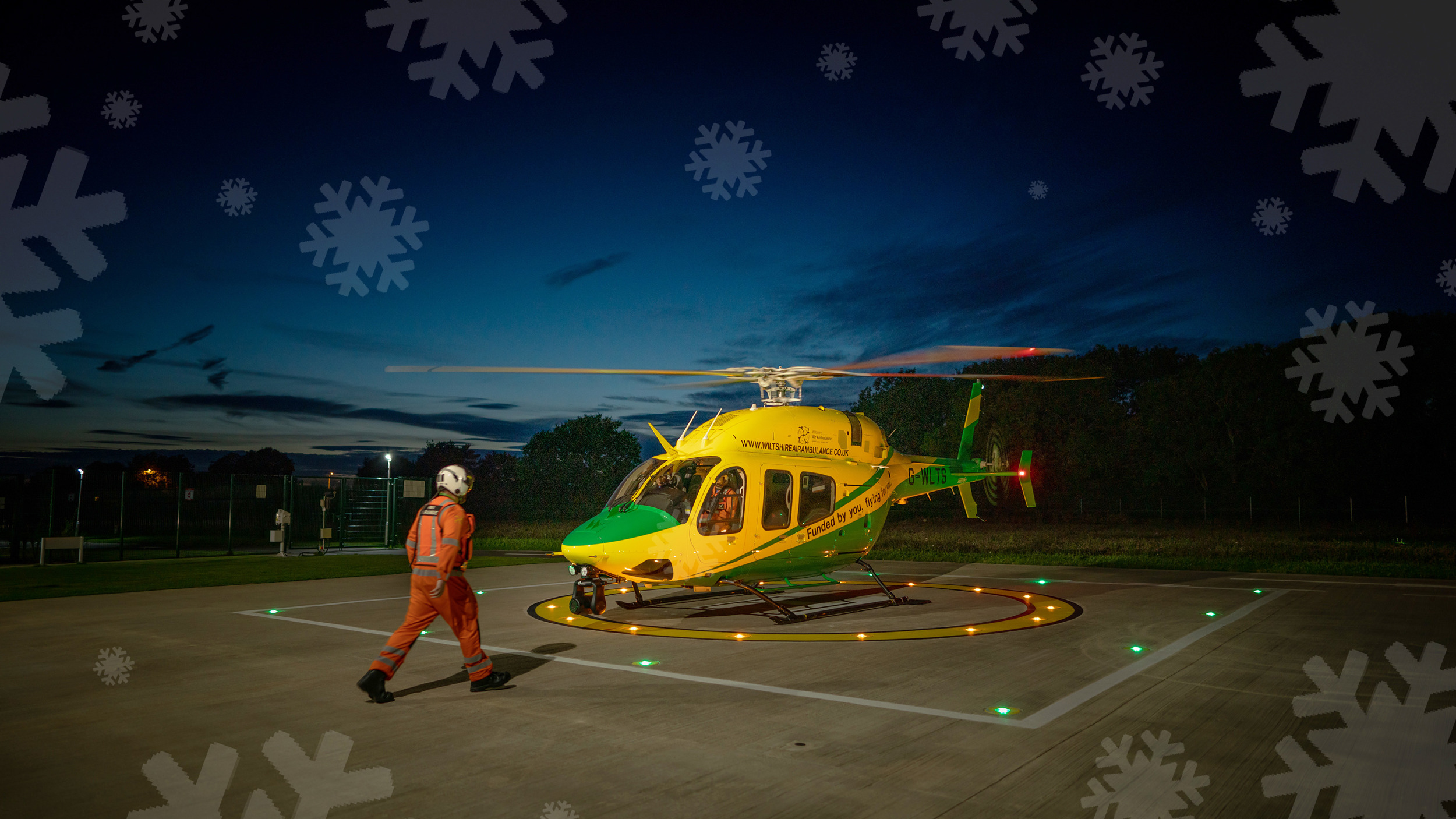 WAA helicopter on a helipad with snowflakes