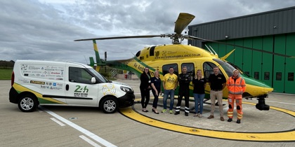 Mike Land with the 24hr van pull vehicle parked on the helipad next to the WAA helicopter