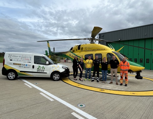 Mike Land with the 24hr van pull vehicle parked on the helipad next to the WAA helicopter