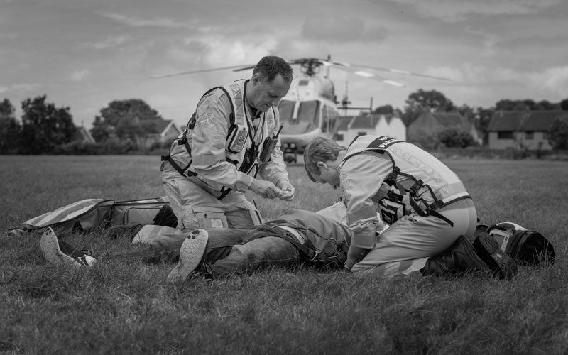 A staged incident in a field where the helicopter has landed nearby