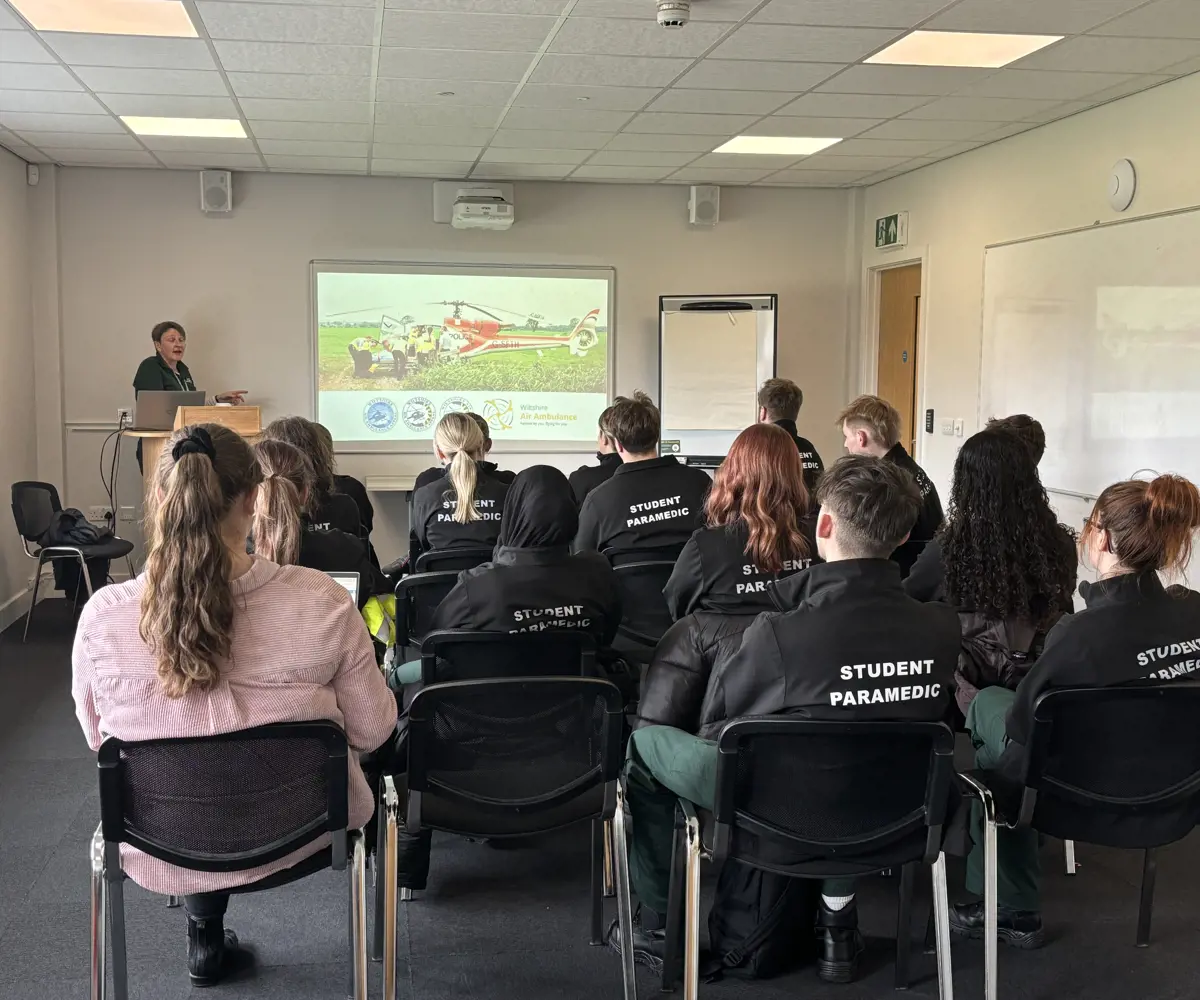 A group of student paramedics sat in seats, looking at a projection A group of student paramedics sat in seats, looking at a projection