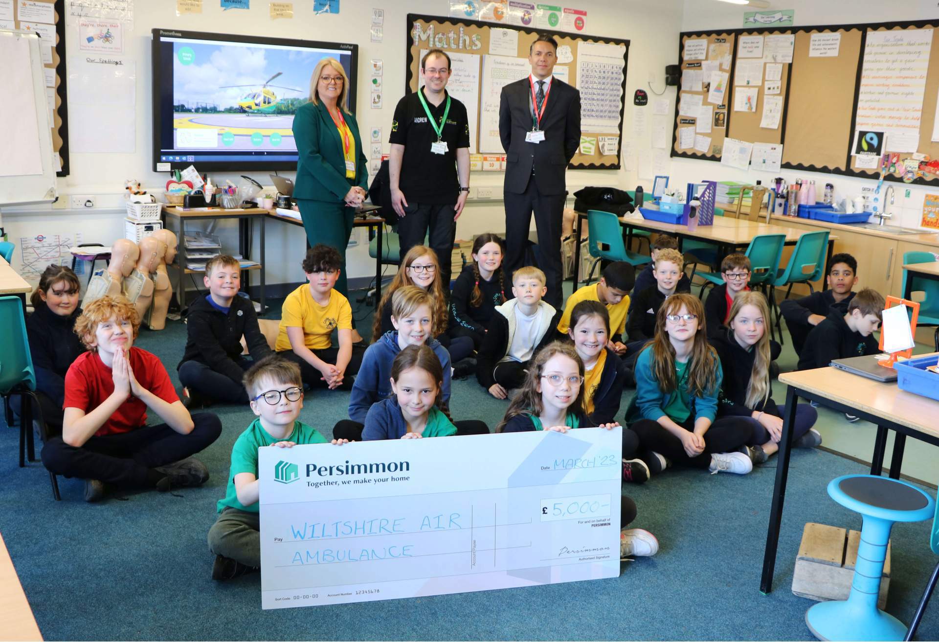Persimmon Homes Wessex hand over a £5,000 cheque to Wiltshire Air Ambulance at Castle Mead School, Trowbridge