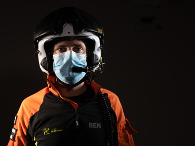 Critical care paramedic Ben Abbott wearing a flight helmet and face mask.