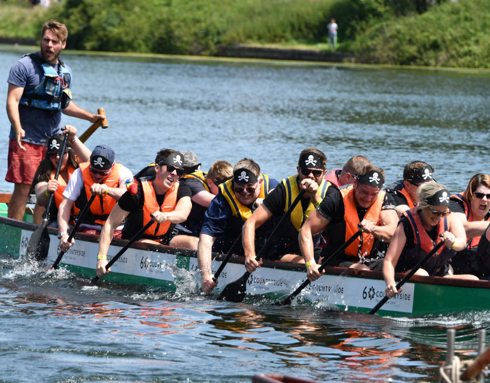 A team taking part in a boat race in aid of WAA