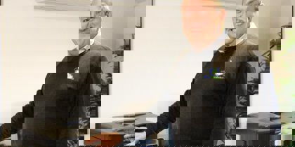 A man posing with a printer