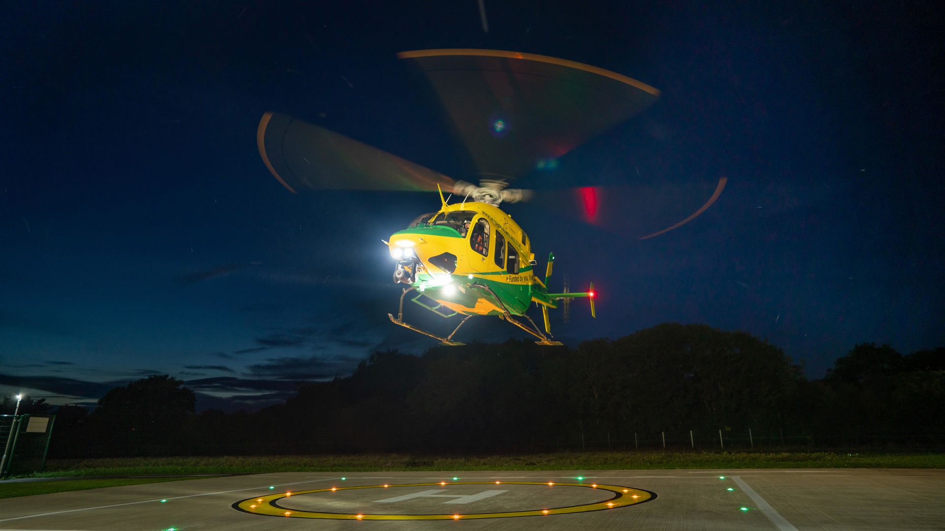 Wiltshire Air Ambulance's helicopter taking off at night